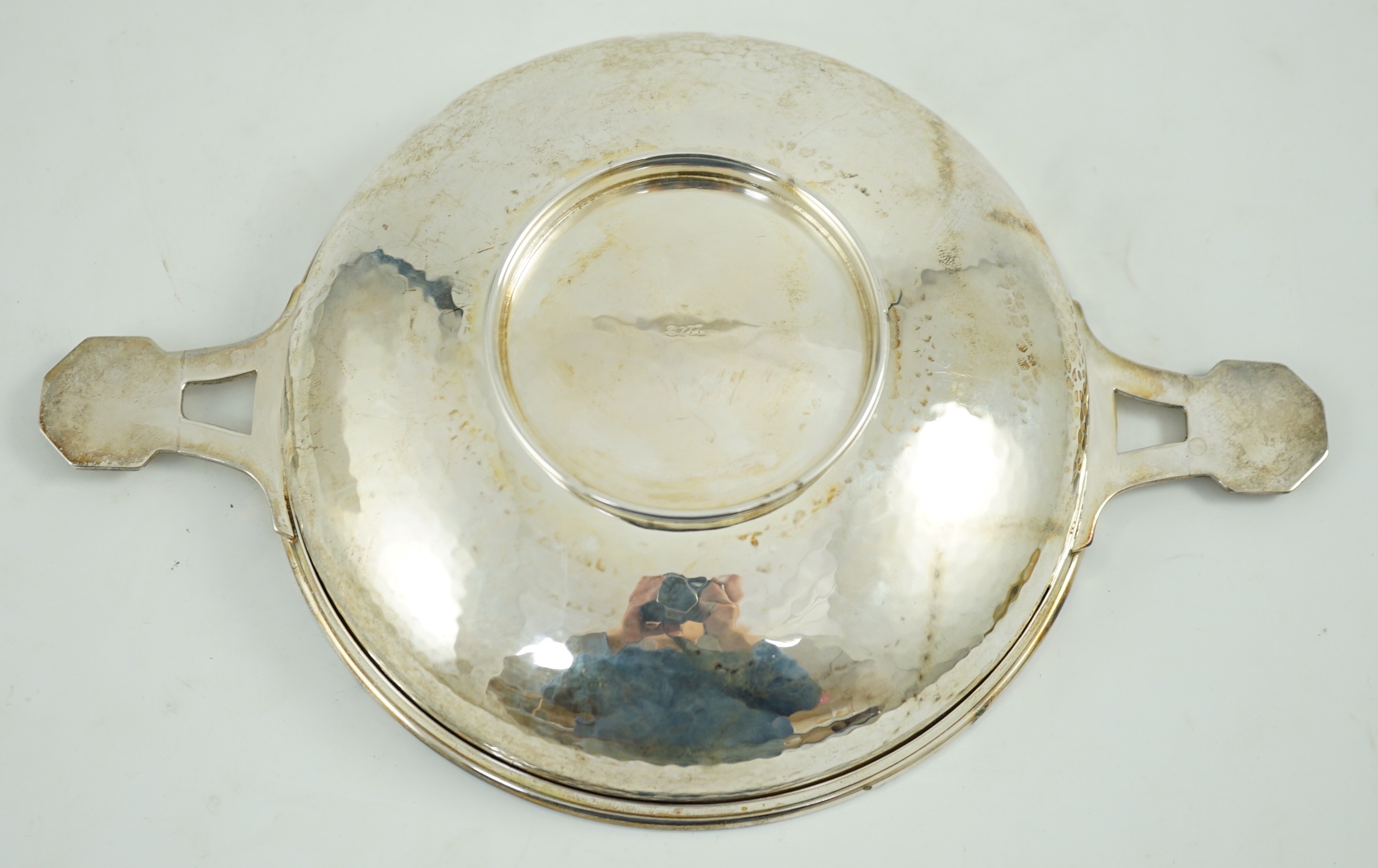 A George V Arts & Crafts planished silver two handled shallow dish, by Albert Edward Jones